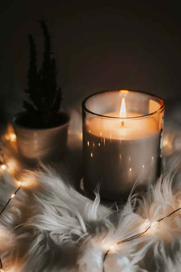 Candle on table with feathers