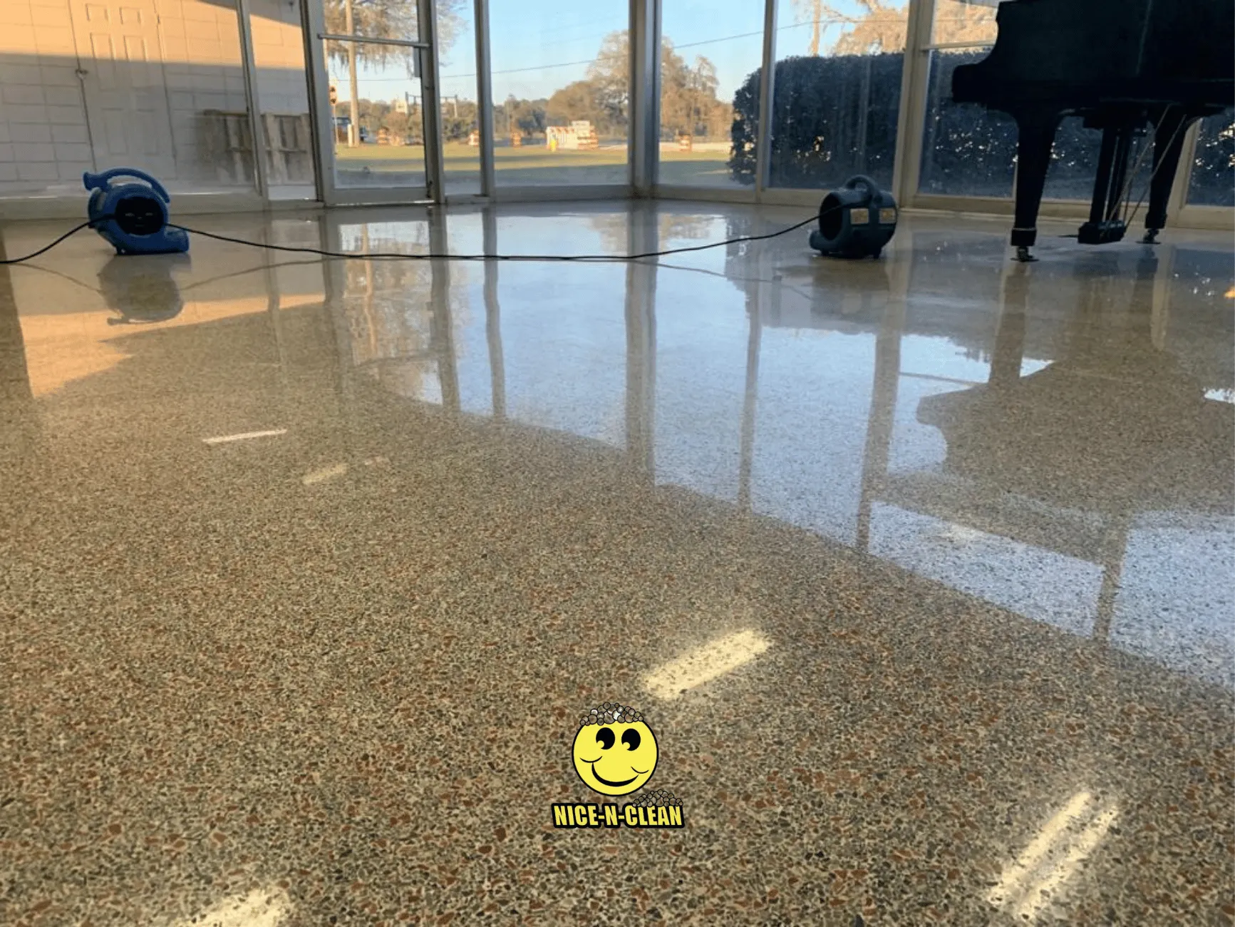 Clean, sealed, polished terrazzo under a grand piano.