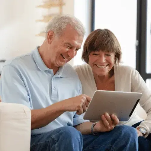 older man and woman with tablet