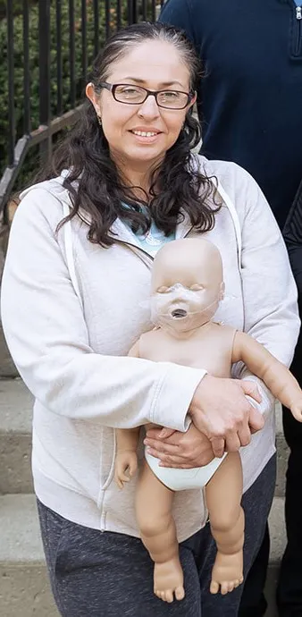 CPR Student holding CPR manikin