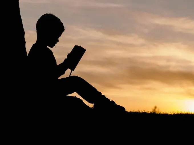 little boy reading a book