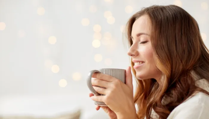 A mom happily drinking coffee.