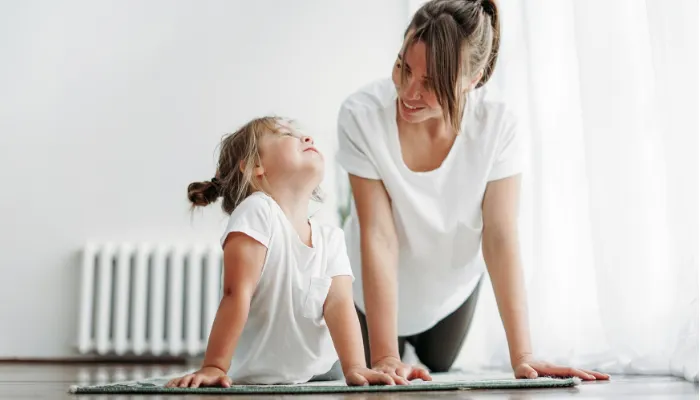 Mom and daughter doing yoga.