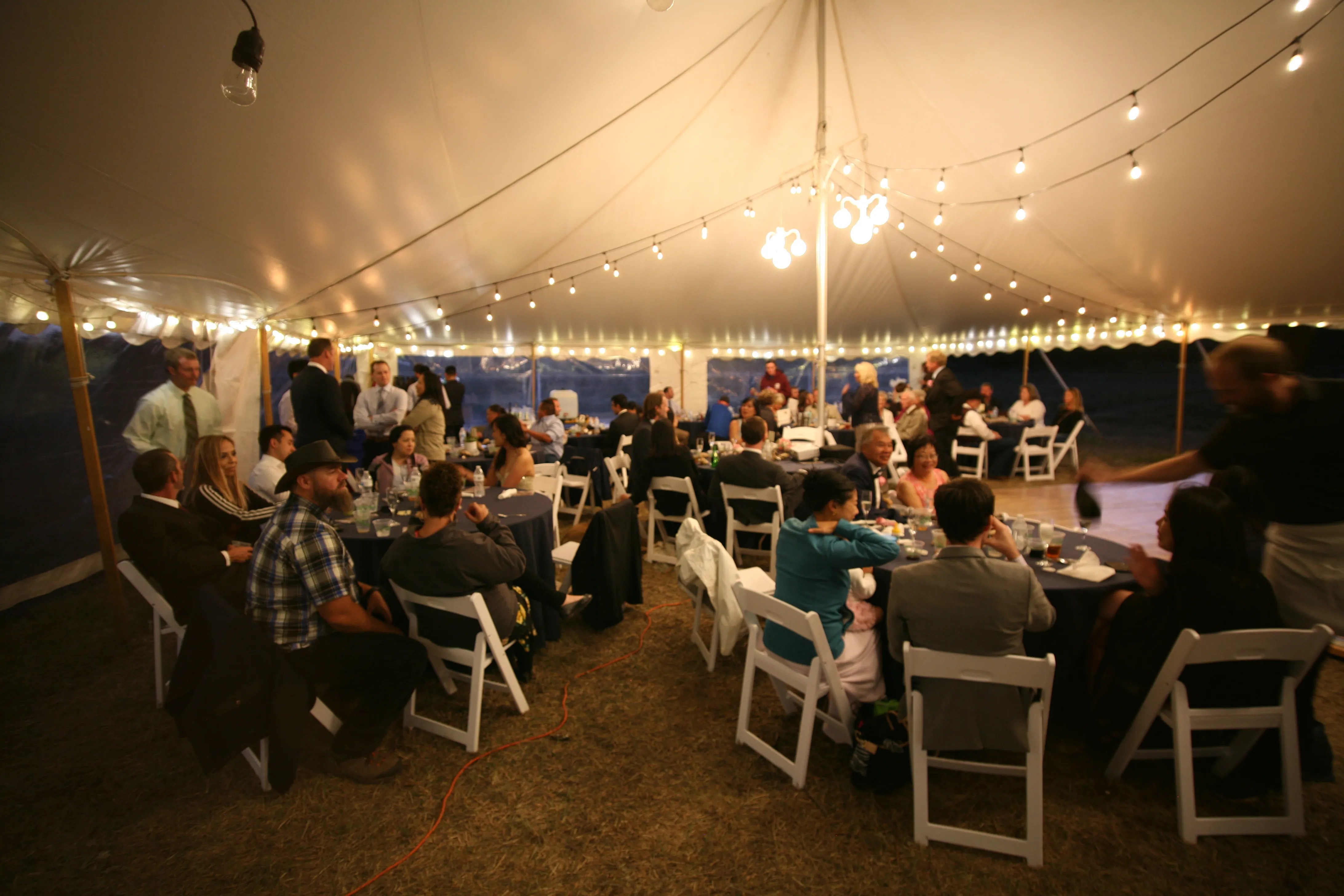 wedding reception in tent at night