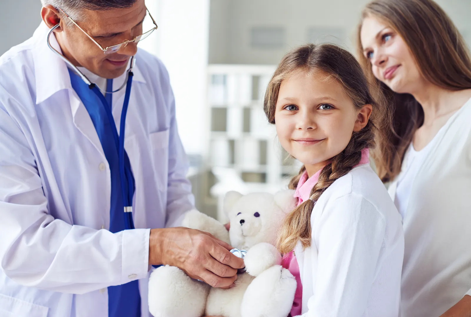 Doctor at a Healthcare clinic treating a child with mother present