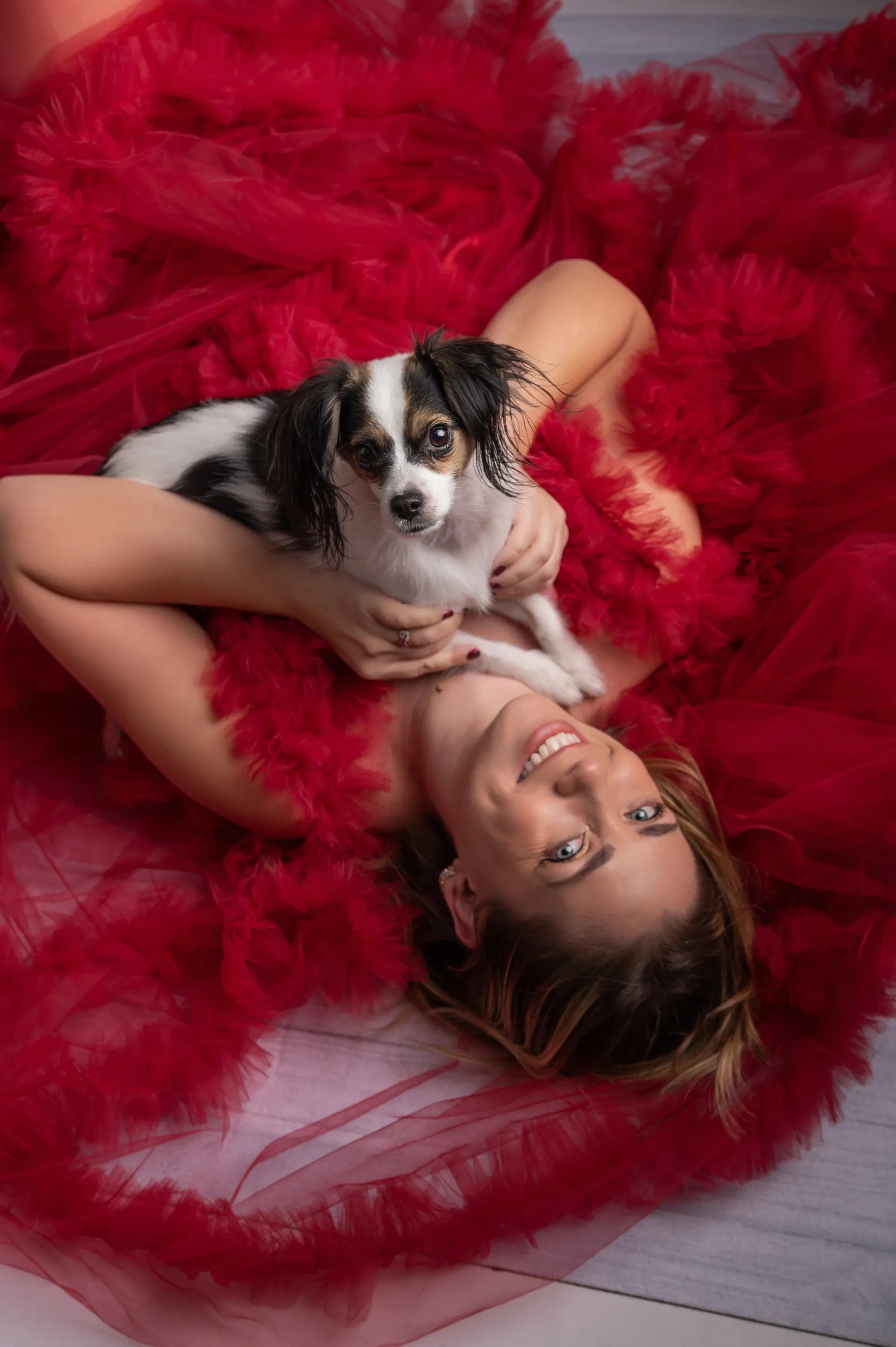 Woman in red dress with small dog