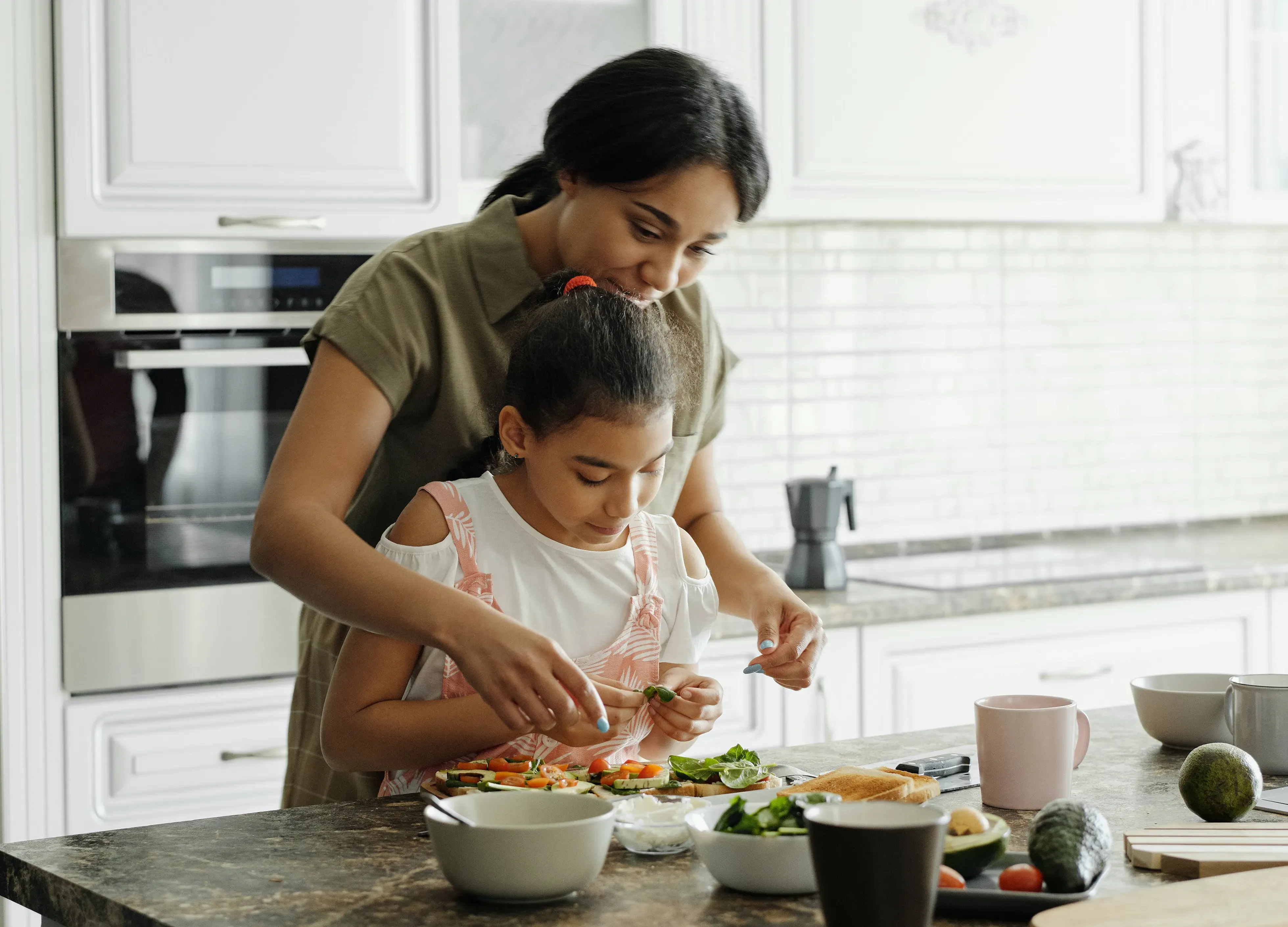 Girl cooking with mum