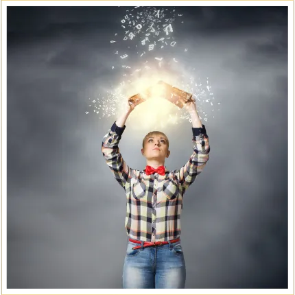 Woman holding her hands up to the sky holding a book with sparkling light shining down