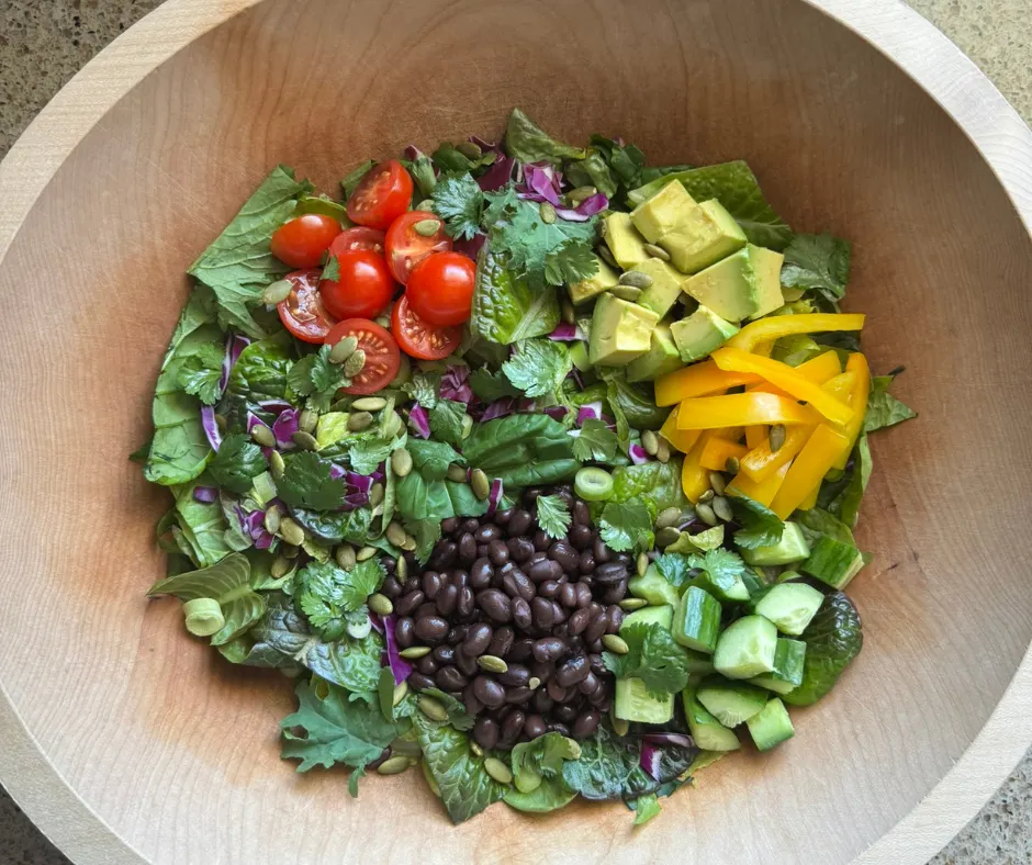 Simple Prep Taco Salad Bowl with black beans, avocado, tomatoes, bell peppers, cucumber, red cabbage, and Creamy Salsa-Lime Dressing.