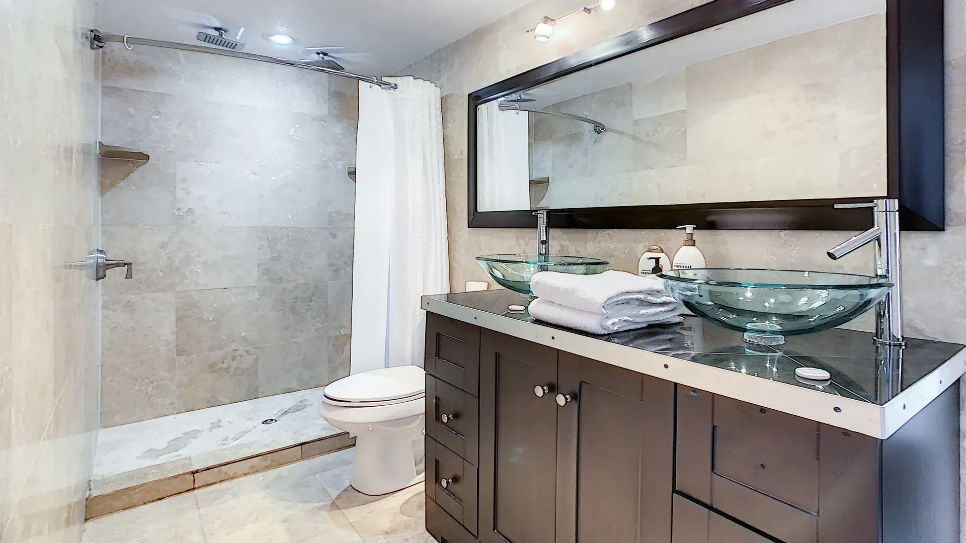 6 Bathrooms with dimmer lights, double sink vanities, shower, bath tub and double mirror wall cabinets at Disney Estate