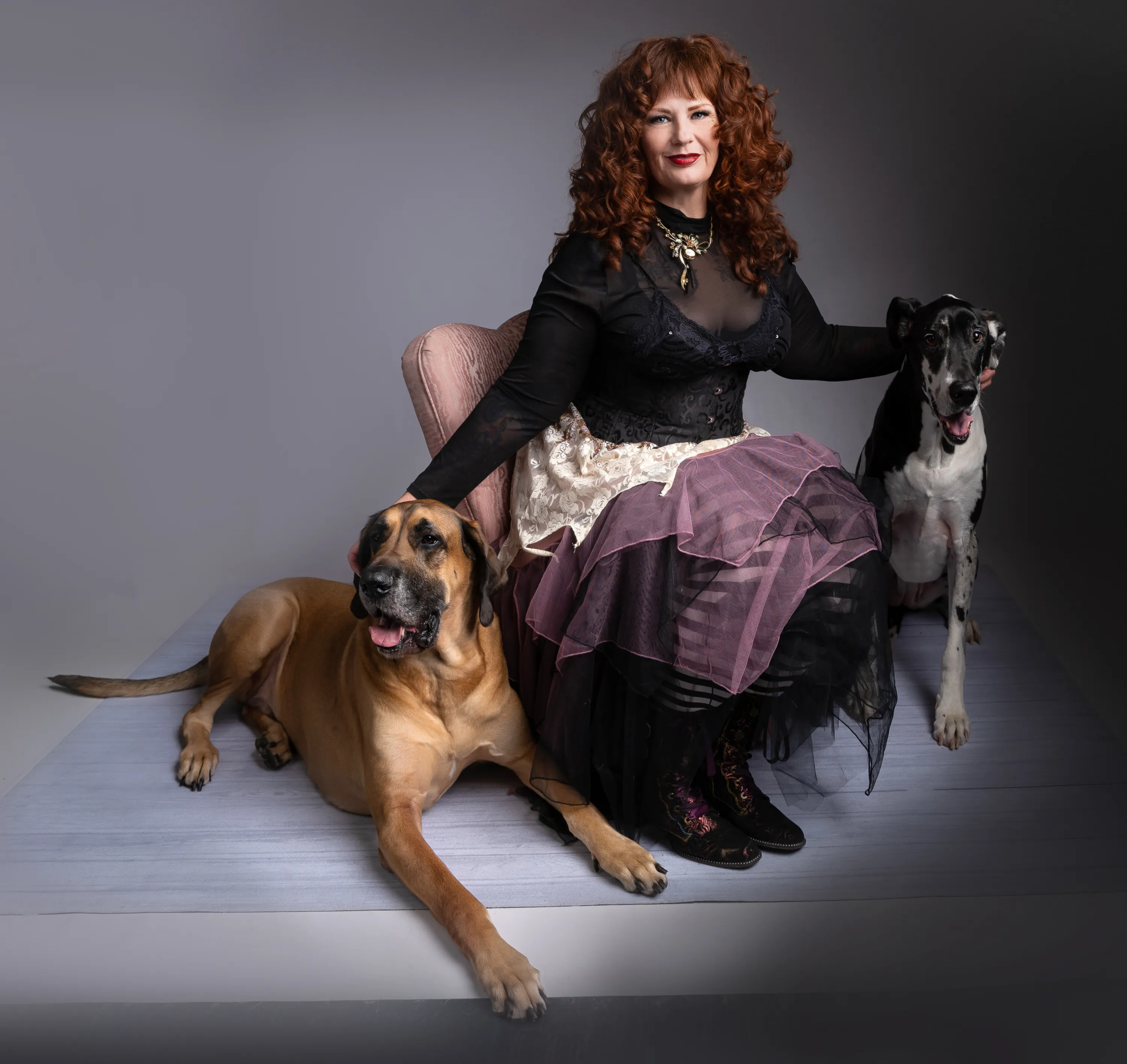 Redhaired woman with two Great Danes