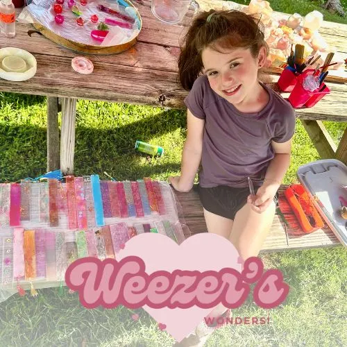 Eloise displaying custom resin and mixed media crafts for Weezer's Wonders