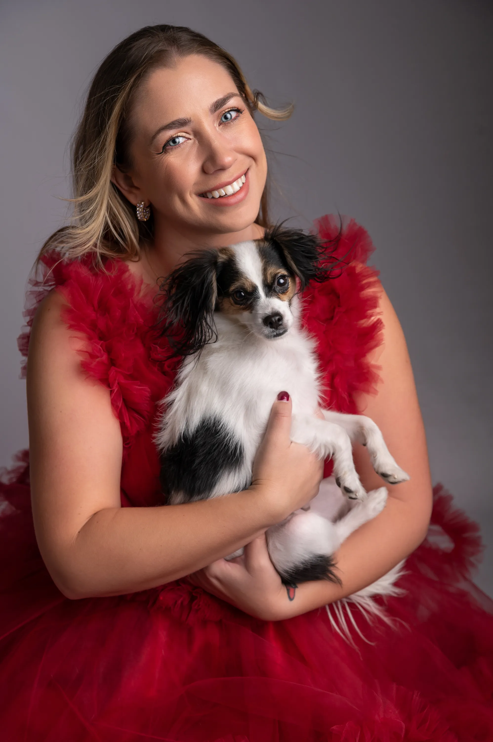 Woman in red dress with small dog