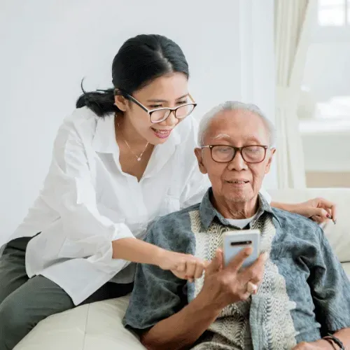 young woman helping older man