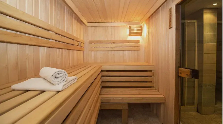 A serene and atmospheric photo of a sauna interior, highlighting the heat and relaxation ambiance.