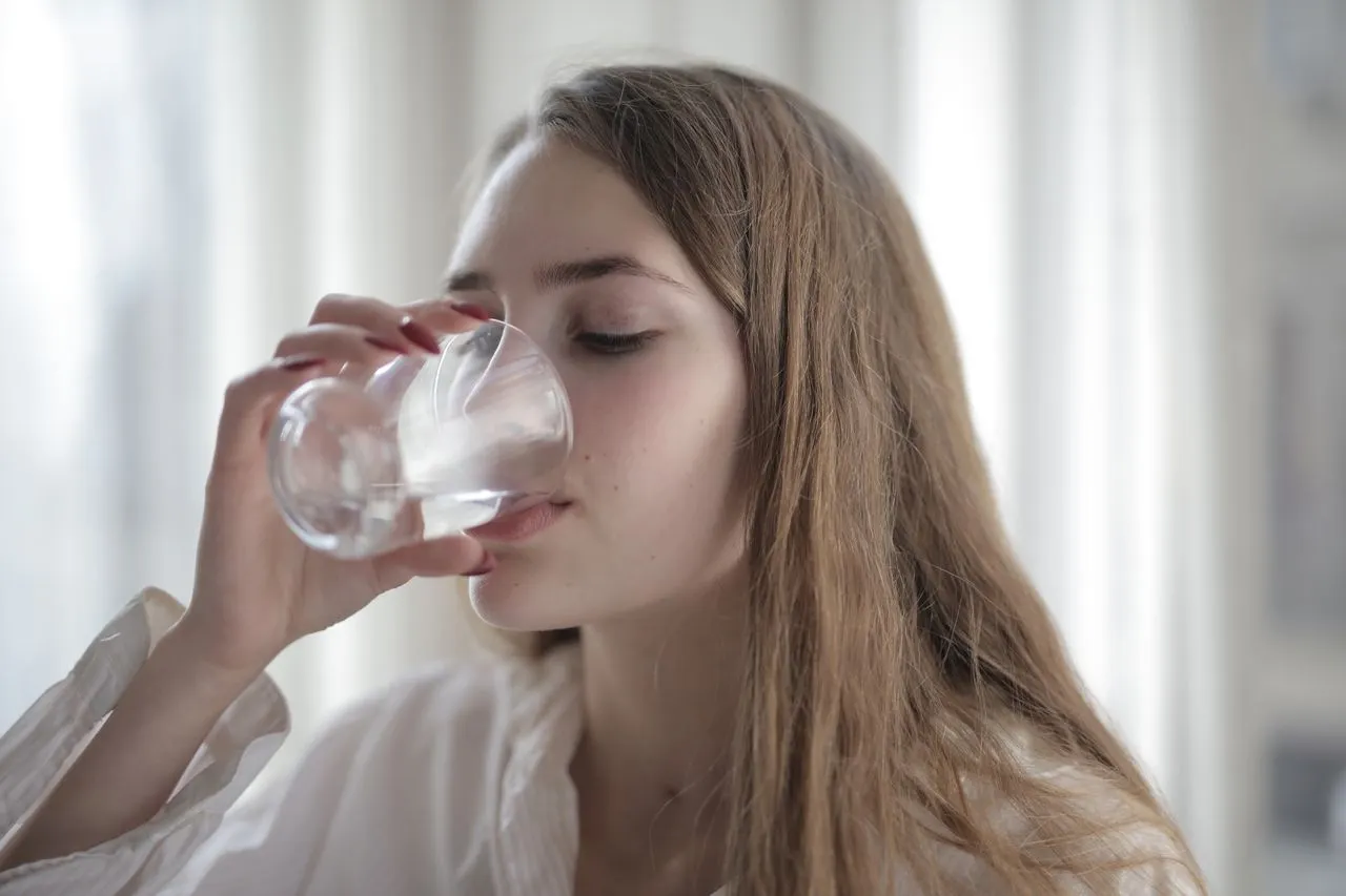 Glass of water with fresh lemon for hydration