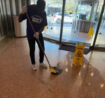 One Way Cleaning Services team performing residential cleaning in a Miami living room, dusting and sanitizing surfaces