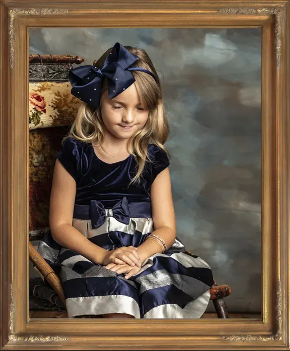 Portrait of young child Petra sitting in her great great grandmother's chair.