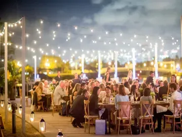 Outdoor dining at bayside restaurant in Villa Laurel Estate