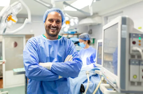 a male anesthesiologist smiling happily