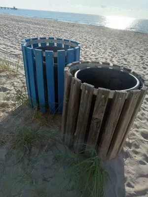 2 trash bins close to the grass away from the shore. Store trash after clean up