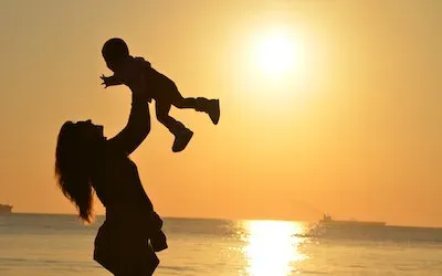 Mother holding child in the air