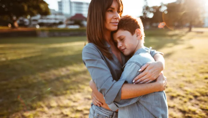 Mom and son hugging.