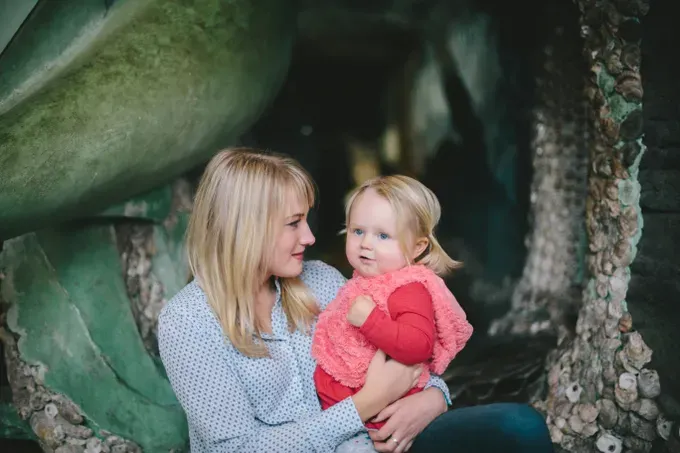 cute baby with mom posing for the camera