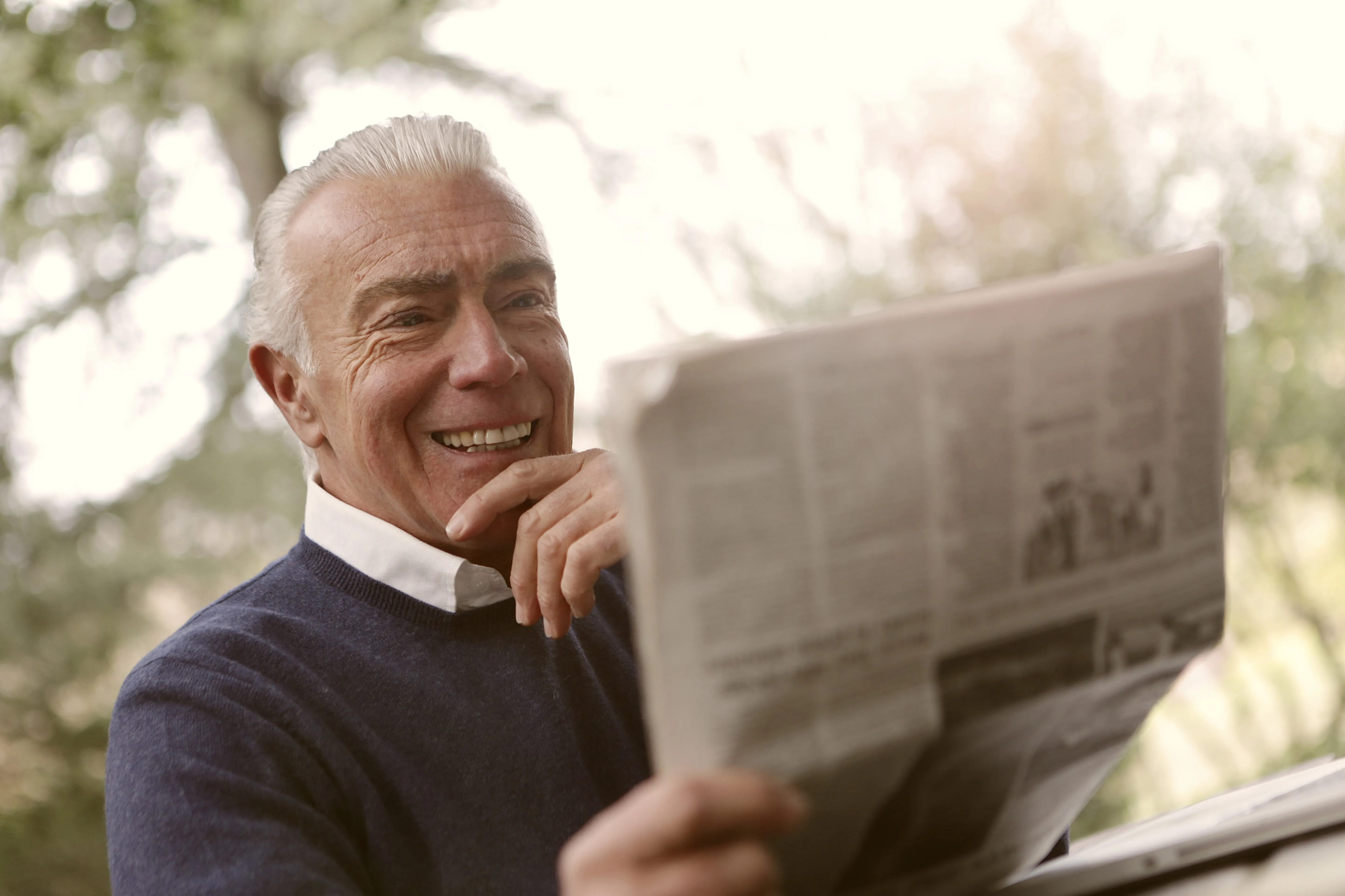 Happy Old Man Reading a Newspaper 