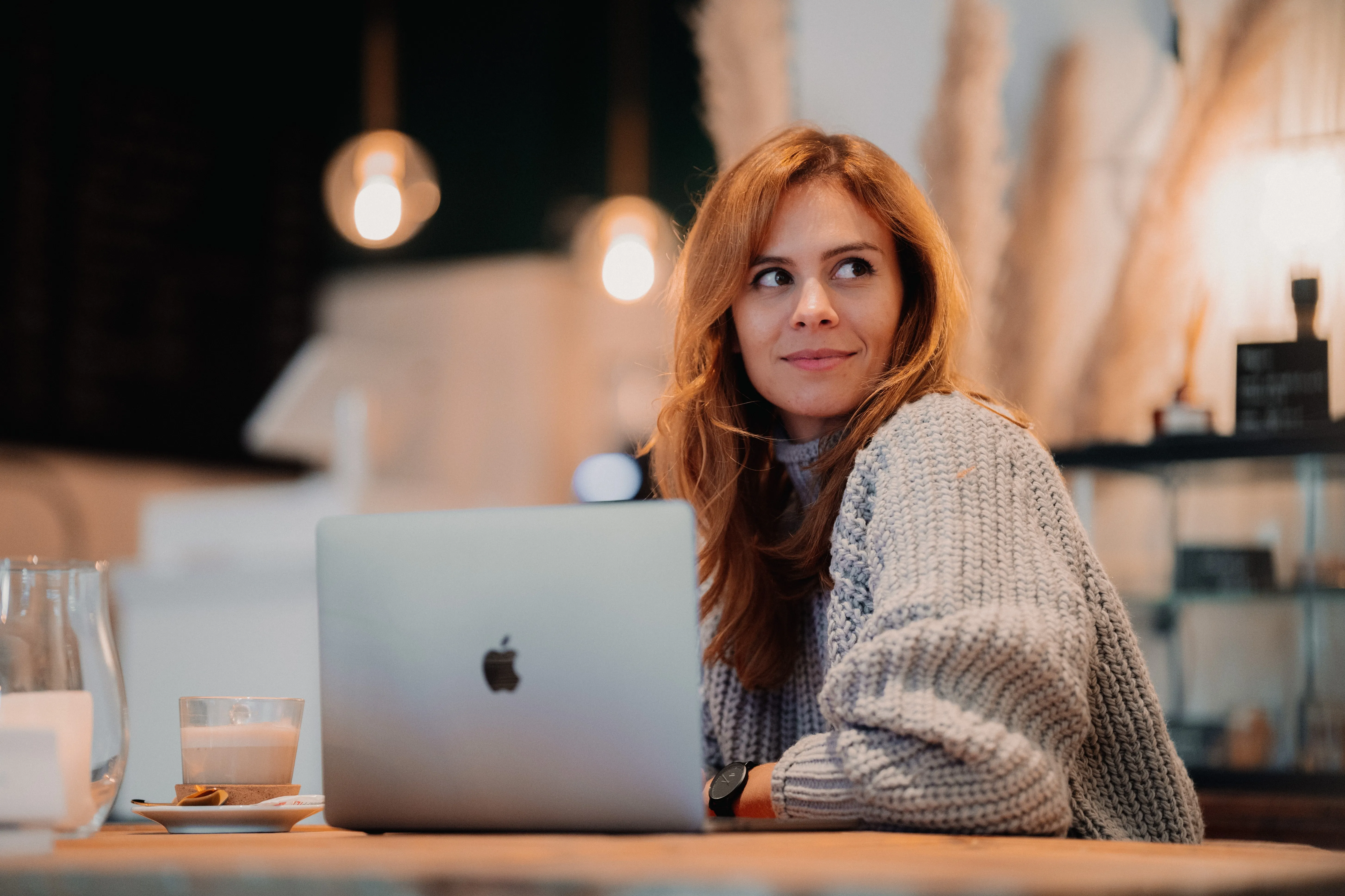 woman in front of laptop smiling