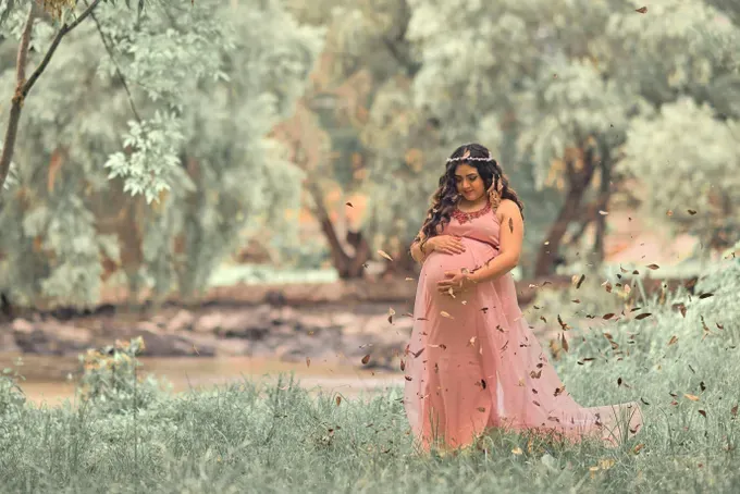 Pregnant woman holding her belly.