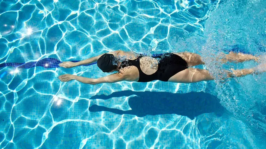 Woman swimming underwater.