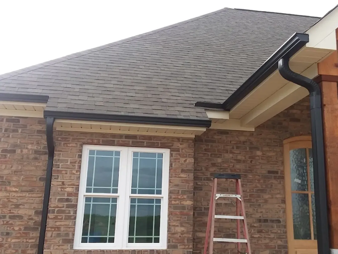 nice brick home with black seamless gutters in Concord, NC