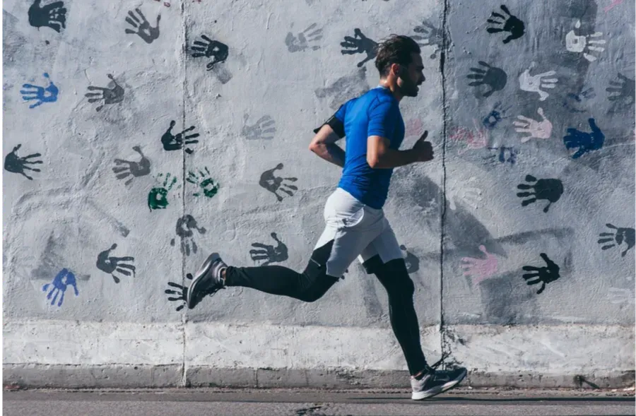 Man running very fast on a city street