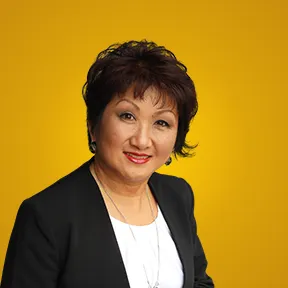 MIchele Ho Lung in Black jacket and whit blouse speaking and white blouse on dark blue background with right third of gold nugget background and FOX ABC & NBC logos