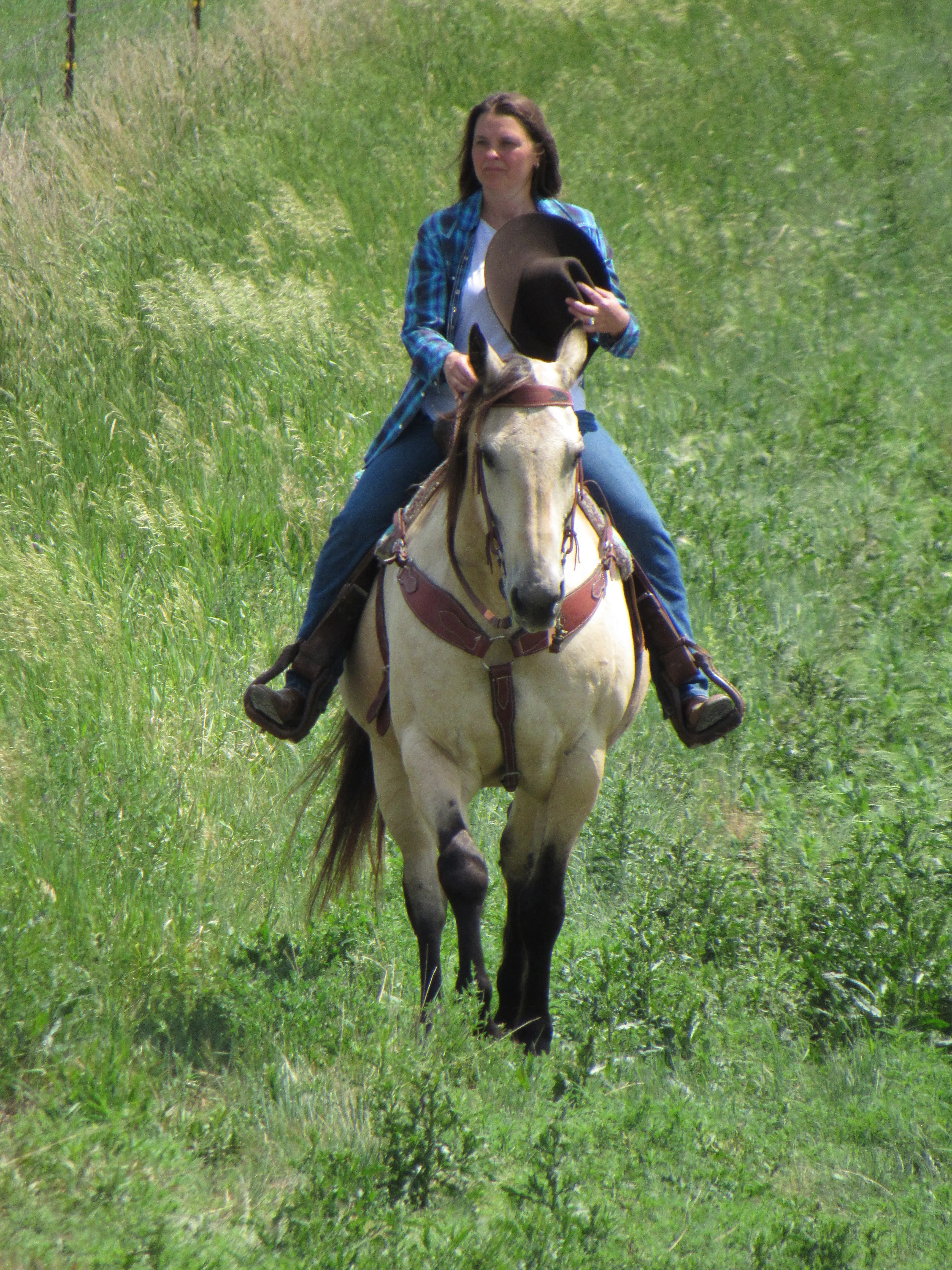 cowgirl standing in farm yard