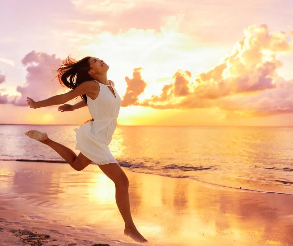 serenity; beach; woman; carefree; freedom; freedom wellness happiness concept - happy woman; happy; carefree; Asian woman feeling blissful jumping; emotional wellness; 