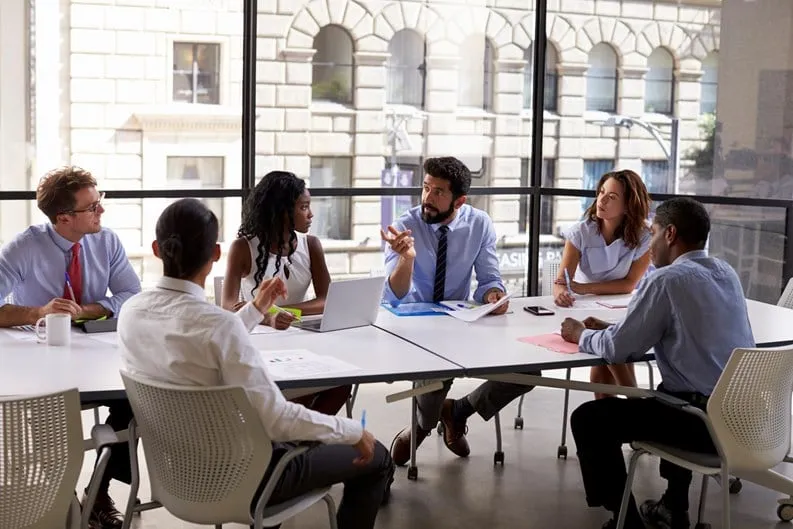 Group of professional real estate brokers discussing in a modern office building