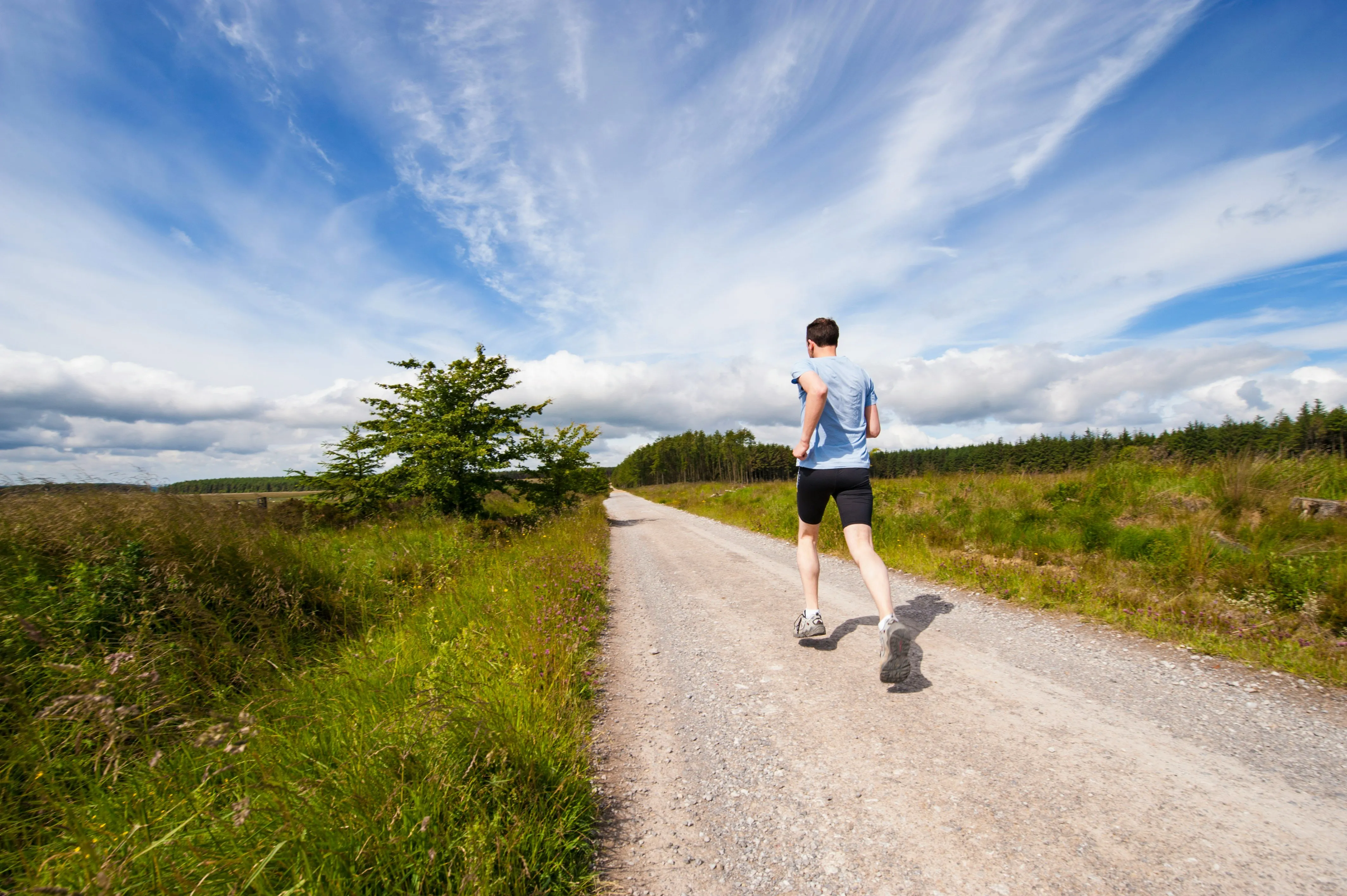 Man running outside on trail