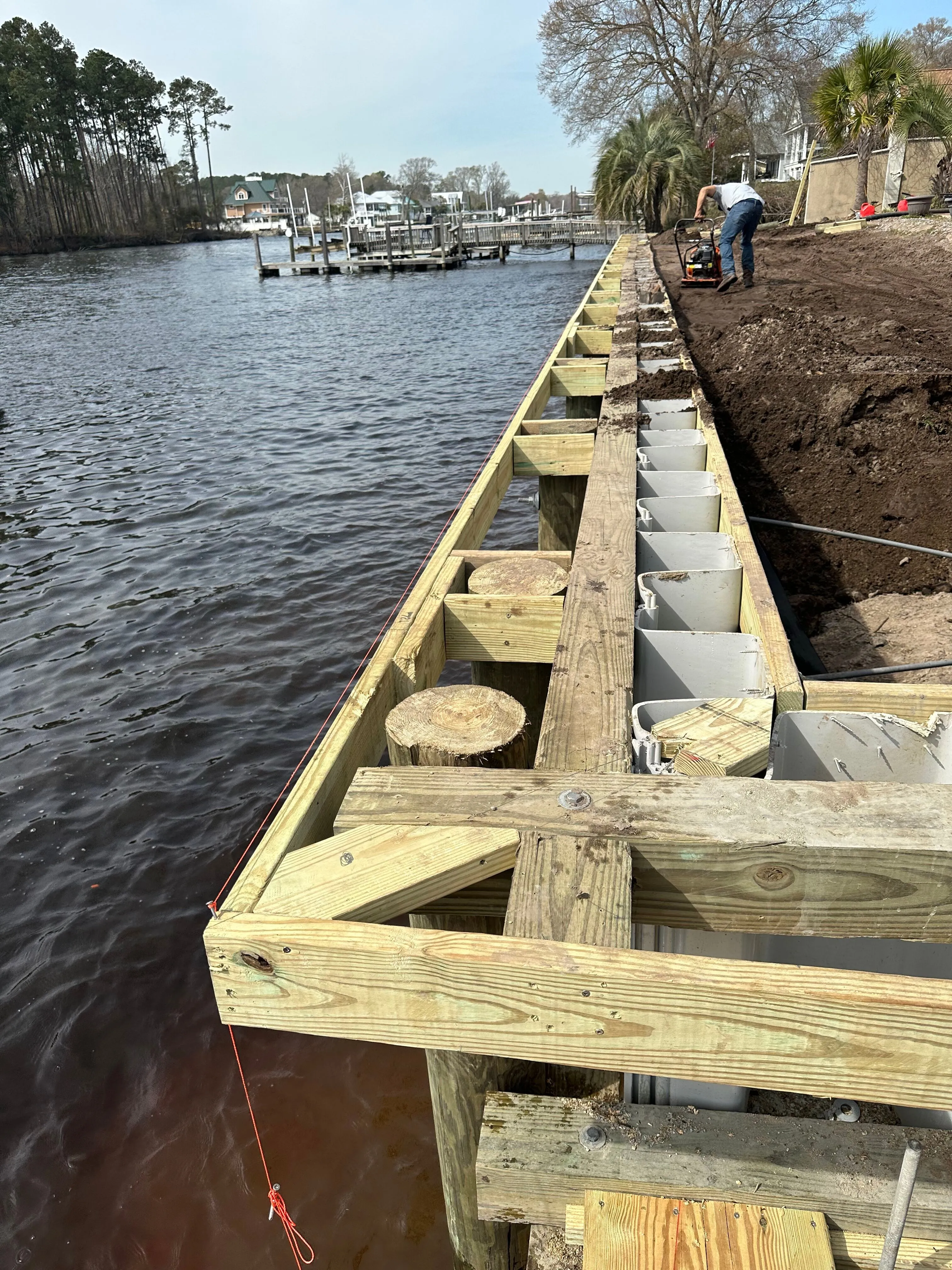 Vinyl Bulkhead with composite wood cap under construction in Myrtle Beach SC on the Intracoastal Waterway built by Waterbridge Contractors of the Carolinas