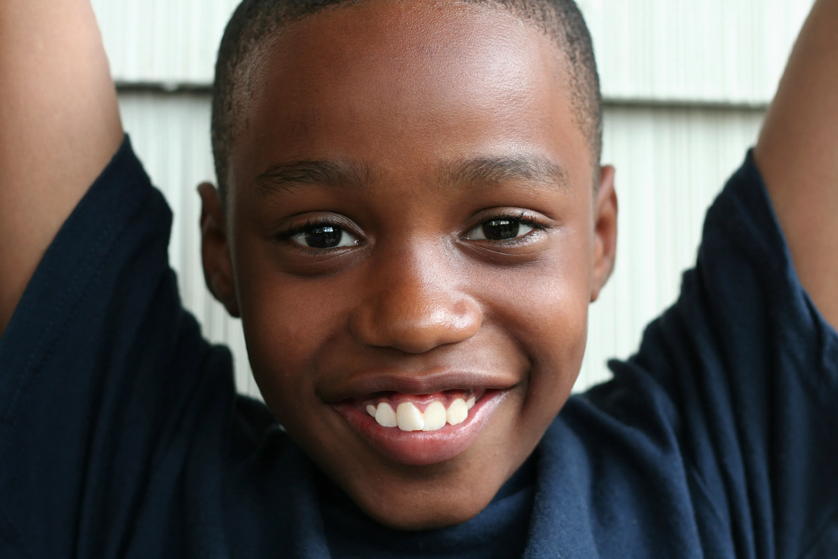 Smiling school-age boy celebrating his success. Smart Processing