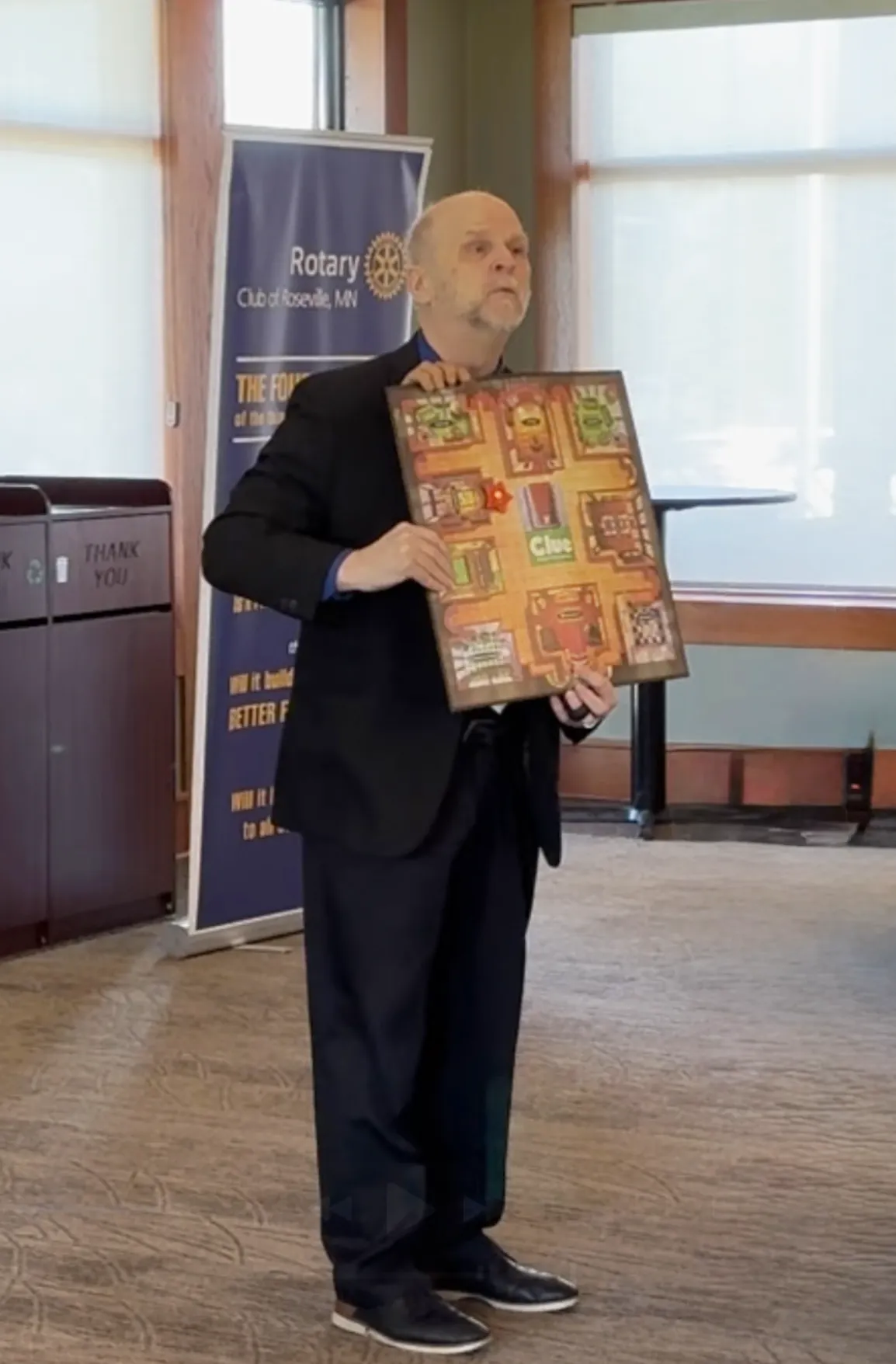 3 hands holding a Clue board