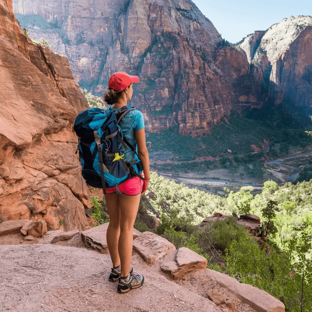 woman backpacking looking at beautiful valley