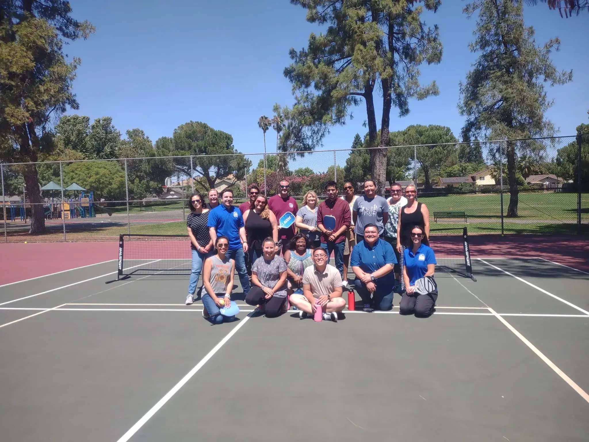 A group of seniors posing on a court