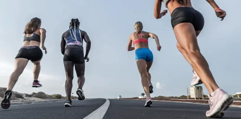 A group of women sprinting on a track.