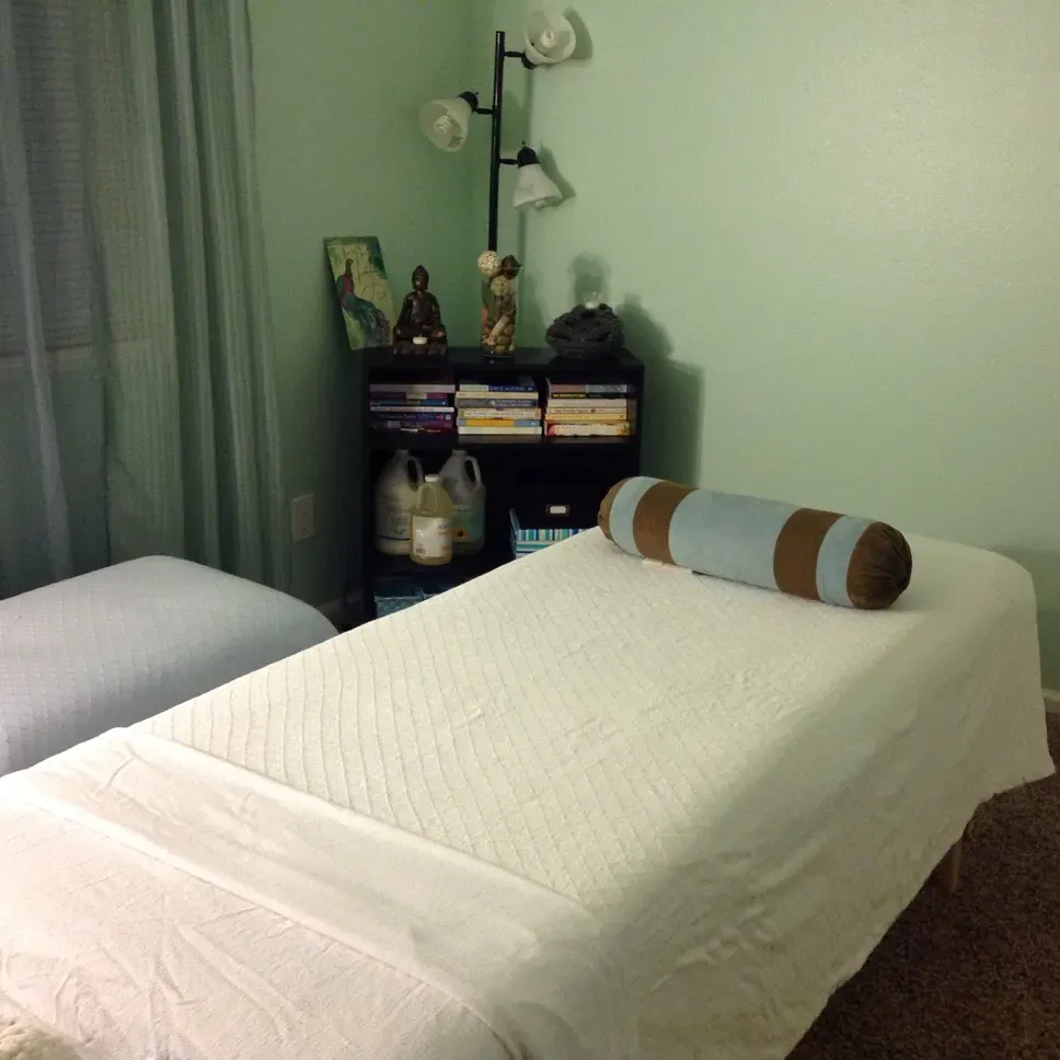 Massage table setup in a calm, home-based setting — reflective of my current in-home perinatal massage care.