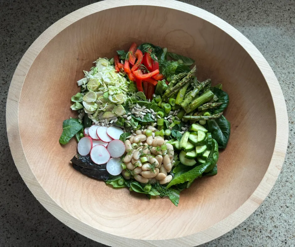 Lemon-dill asparagus and white bean salad with radishes, red pepper, cucumber, and shaved Brussels sprouts before dressing