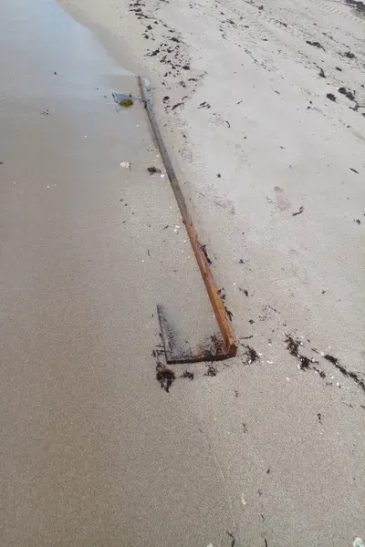 a length of board embedded in the sand