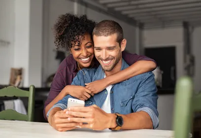 Happy couple looking at phone