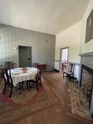 dining room at Patrick Henrys Scotchtown with fireplace table setting and portrait of Madame Russell